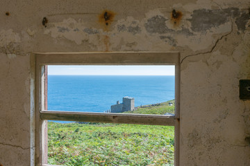 view of the ocean through a ruined house