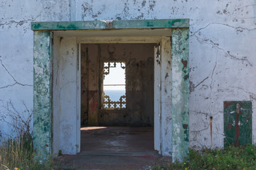 view of the ocean through a ruined house