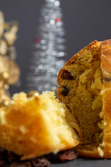 Christmas Panettone with slice and preparing ingredients to make panettone with egg, milk, and raisins setting. Typical Italian Christmas holiday cake