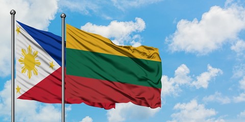 Philippines and Lithuania flag waving in the wind against white cloudy blue sky together. Diplomacy...