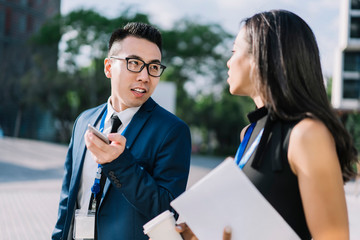 Communicating young business people on street