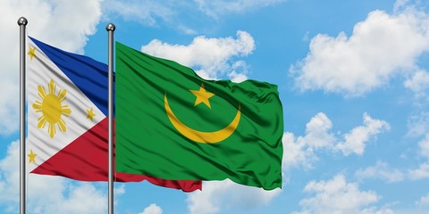 Philippines and Mauritania flag waving in the wind against white cloudy blue sky together. Diplomacy concept, international relations.