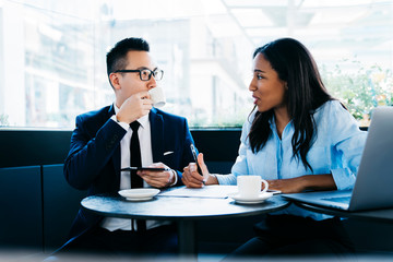 Modern diverse business people working in cafe