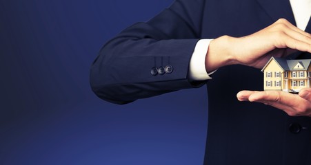 Businessman Holding House Model, Real Estate Concept