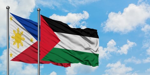 Philippines and Palestine flag waving in the wind against white cloudy blue sky together. Diplomacy concept, international relations.