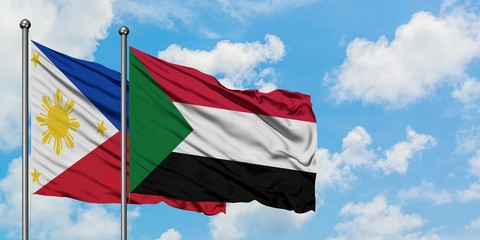Philippines and Sudan flag waving in the wind against white cloudy blue sky together. Diplomacy concept, international relations.