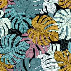 Tropical leaves seamless pattern on black background.