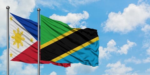 Philippines and Tanzania flag waving in the wind against white cloudy blue sky together. Diplomacy concept, international relations.