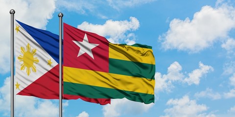 Philippines and Togo flag waving in the wind against white cloudy blue sky together. Diplomacy concept, international relations.