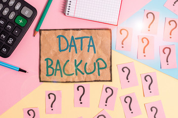 Writing note showing Data Backup. Business concept for copy of important data that is stored on an alternative location Mathematics stuff and writing equipment above pastel colours background