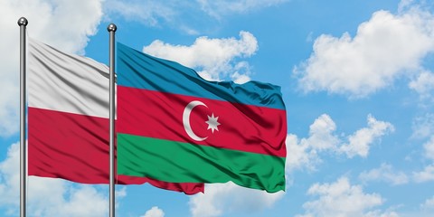 Poland and Azerbaijan flag waving in the wind against white cloudy blue sky together. Diplomacy concept, international relations.