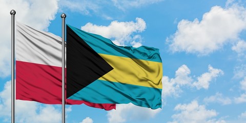 Poland and Bahamas flag waving in the wind against white cloudy blue sky together. Diplomacy concept, international relations.