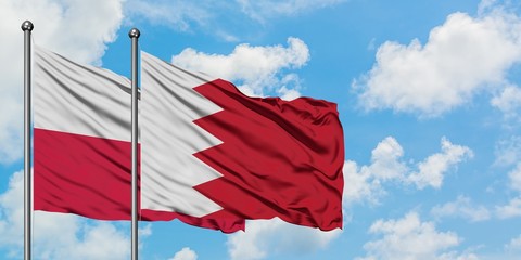Poland and Bahrain flag waving in the wind against white cloudy blue sky together. Diplomacy concept, international relations.