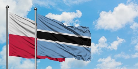 Poland and Botswana flag waving in the wind against white cloudy blue sky together. Diplomacy...