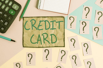 Writing note showing Credit Card. Business concept for card that allows you to borrow money against a line of credit Mathematics stuff and writing equipment above pastel colours background