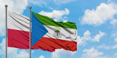 Poland and Equatorial Guinea flag waving in the wind against white cloudy blue sky together. Diplomacy concept, international relations.