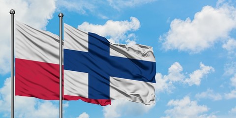Poland and Finland flag waving in the wind against white cloudy blue sky together. Diplomacy concept, international relations.