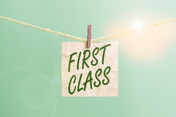 Text sign showing First Class. Business photo showcasing the most expensive and most luxurious class of accommodation Clothesline clothespin rectangle shaped paper reminder white wood desk