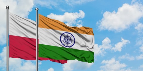 Poland and India flag waving in the wind against white cloudy blue sky together. Diplomacy concept,...