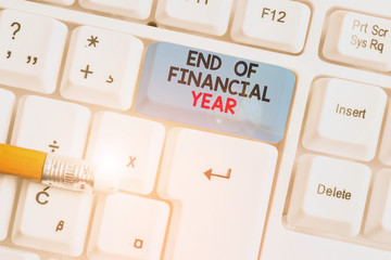 Writing note showing End Of Financial Year. Business concept for Revise and edit accounting sheets...