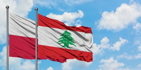 Poland and Lebanon flag waving in the wind against white cloudy blue sky together. Diplomacy concept, international relations.