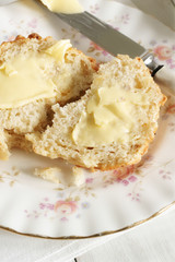 Savoury cheese scones spread with butter