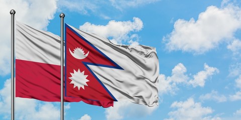 Poland and Nepal flag waving in the wind against white cloudy blue sky together. Diplomacy concept, international relations.