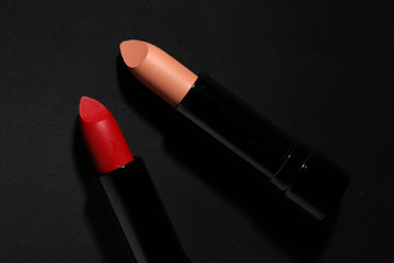 Fototapeta premium Lipstick. Fashion Colorful Lipsticks over black background. Lipstick tints palette, Professional Makeup and Beauty. Beautiful Make-up concept. Lipgloss. Lipsticks closeup