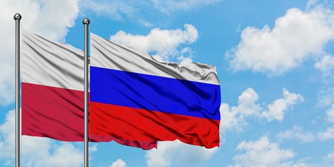Poland and Russia flag waving in the wind against white cloudy blue sky together. Diplomacy concept, international relations.