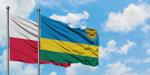 Poland and Rwanda flag waving in the wind against white cloudy blue sky together. Diplomacy concept, international relations.