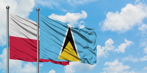 Poland and Saint Lucia flag waving in the wind against white cloudy blue sky together. Diplomacy concept, international relations.
