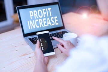 Text sign showing Profit Increase. Business photo text the growth in the amount of revenue gained from a business woman laptop computer smartphone mug office supplies technological devices