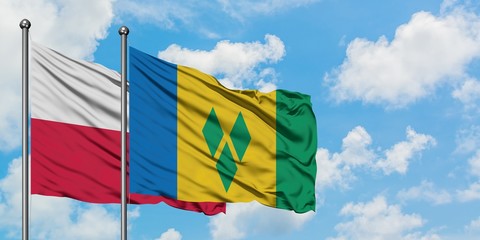 Poland and Saint Vincent And The Grenadines flag waving in the wind against white cloudy blue sky together. Diplomacy concept, international relations.