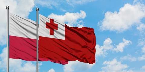 Poland and Tonga flag waving in the wind against white cloudy blue sky together. Diplomacy concept, international relations.
