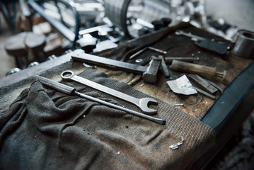 Fototapeta premium Place of work. Tools on dirty table. In garage. Manufactory conception