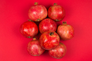 Sweet pomegranate on red background.