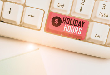 Word writing text Holiday Hours. Business photo showcasing employee receives twice their normal pay for all hours White pc keyboard with empty note paper above white background key copy space