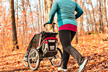 Stroller woman running in an autumn park they run a race or train in a healthy outdoors lifestyle...
