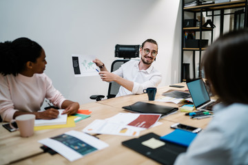 Happy male and female partners discussing new finance report with corporate productivity for future startup project, cheerful man communicating in office company and analyzing exchange occupation