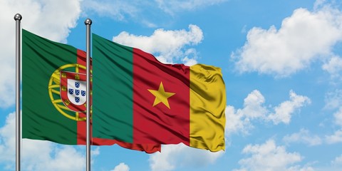 Portugal and Cameroon flag waving in the wind against white cloudy blue sky together. Diplomacy concept, international relations.