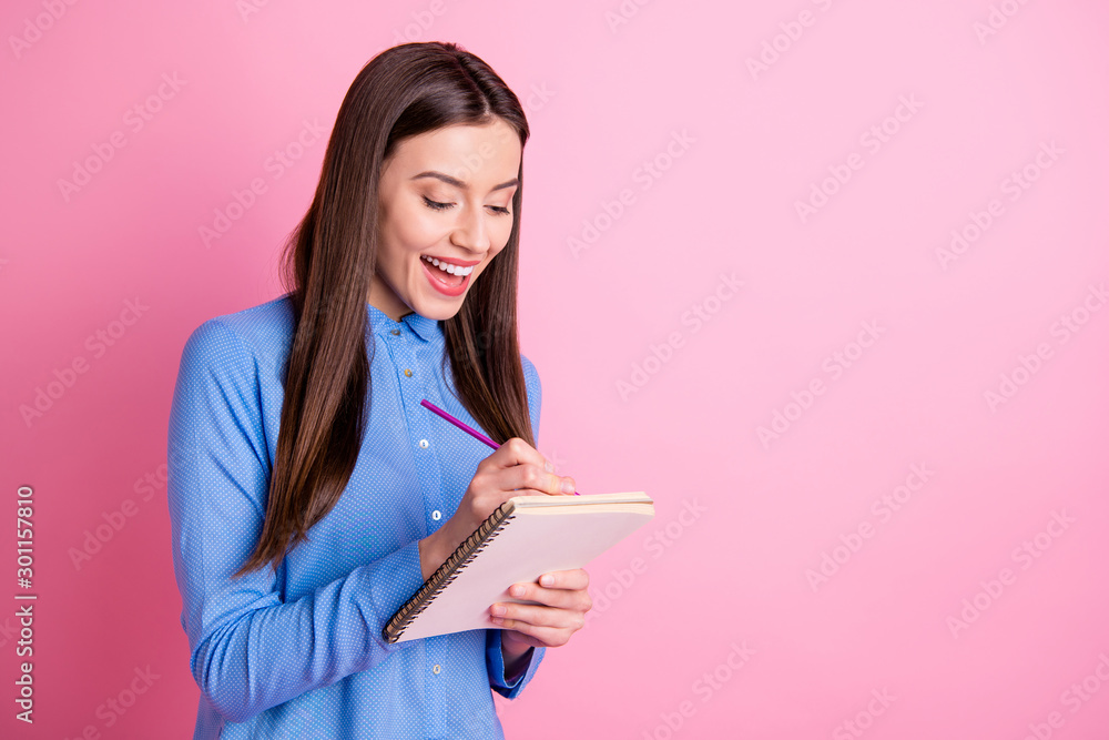 Wall mural Copyspace photo of cheerful charming cute attractive fascinating girlfriend calculating something on her copybook writing with pencil isolated over pink pastel color background