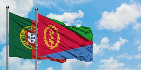 Portugal and Eritrea flag waving in the wind against white cloudy blue sky together. Diplomacy concept, international relations.