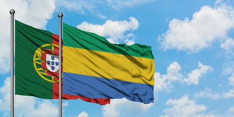 Portugal and Gabon flag waving in the wind against white cloudy blue sky together. Diplomacy concept, international relations.