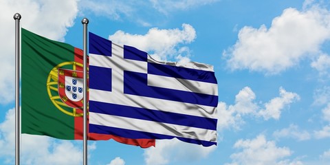 Portugal and Greece flag waving in the wind against white cloudy blue sky together. Diplomacy...