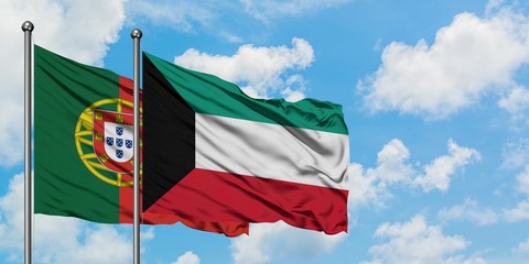 Portugal and Kuwait flag waving in the wind against white cloudy blue sky together. Diplomacy...