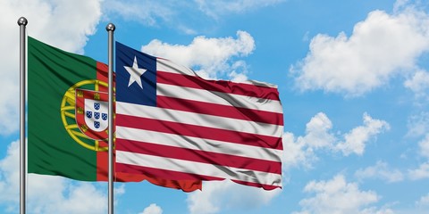 Portugal and Liberia flag waving in the wind against white cloudy blue sky together. Diplomacy concept, international relations.
