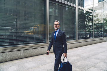 Handsome mature man striding down street