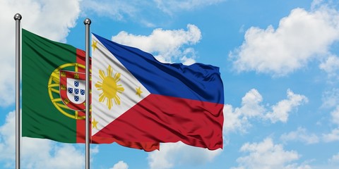 Portugal and Philippines flag waving in the wind against white cloudy blue sky together. Diplomacy concept, international relations.
