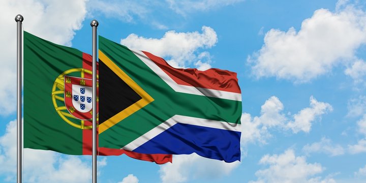 Portugal and South Africa flag waving in the wind against white cloudy blue sky together. Diplomacy concept, international relations.
