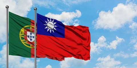 Portugal and Taiwan flag waving in the wind against white cloudy blue sky together. Diplomacy concept, international relations.